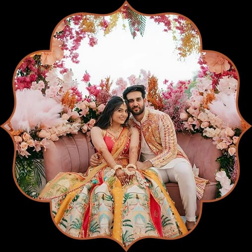 Couple seated together on a flower-decked stage